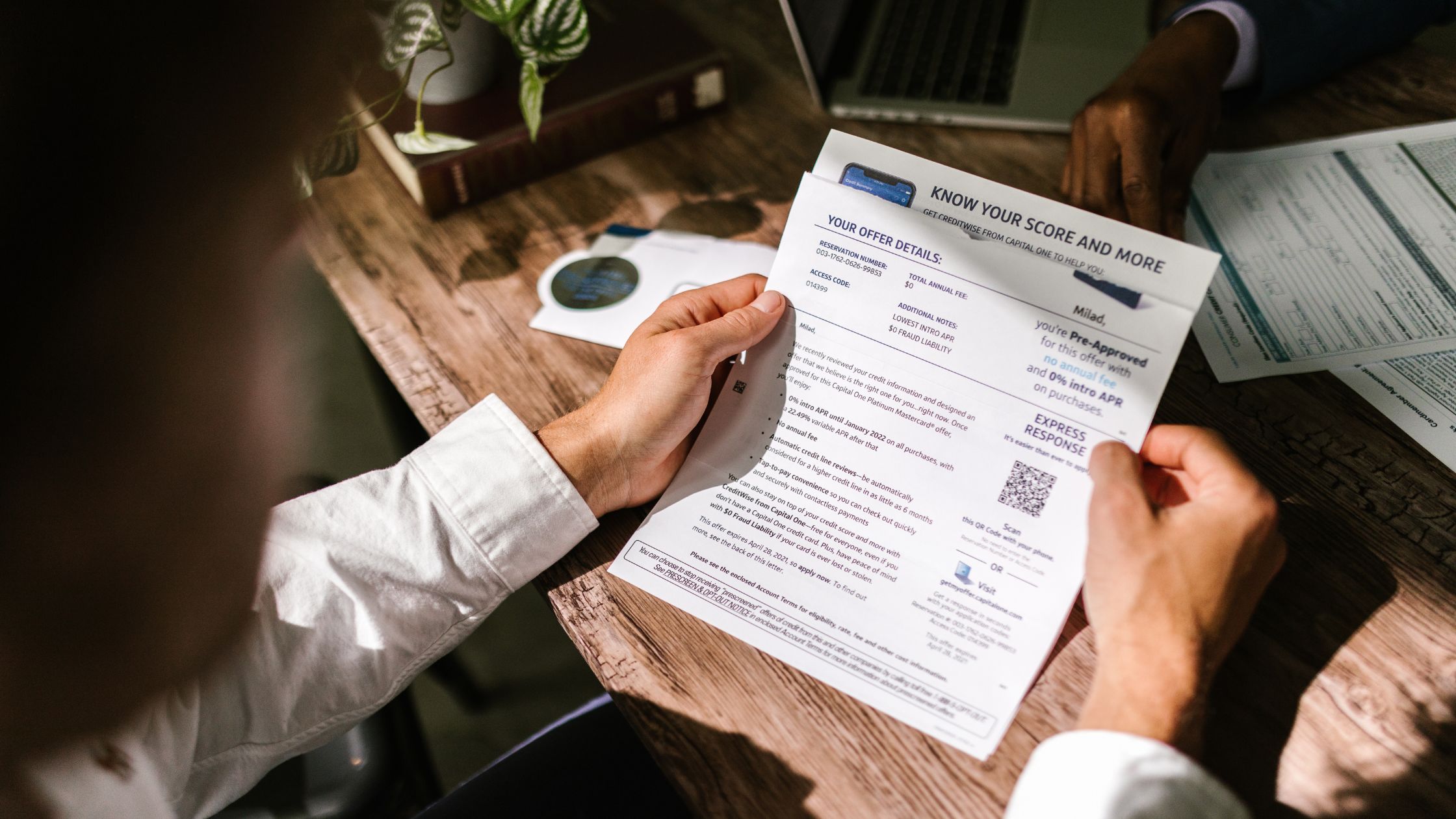 man looking at credit approval papers